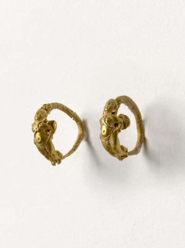 Pair of hoop earrings featuring a winged figure
